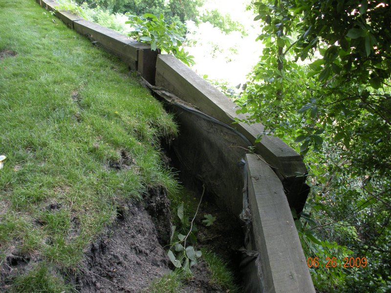 The weight of an unsecured retaining wall can increase the instability of the bluff.  As erosion occurs the retaining wall becomes exposed.